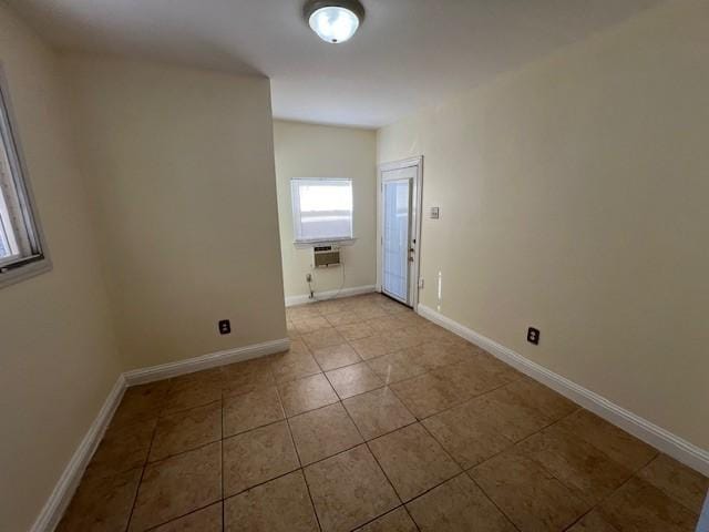 empty room with tile patterned floors and baseboards