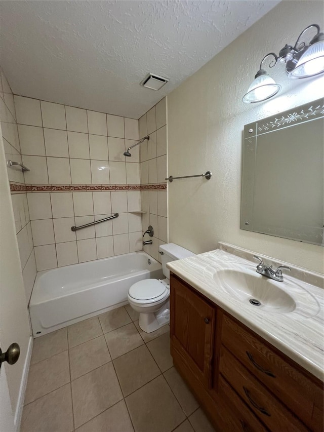 bathroom featuring shower / washtub combination, toilet, a textured ceiling, vanity, and tile patterned floors