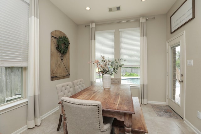 dining room with baseboards, a healthy amount of sunlight, and visible vents