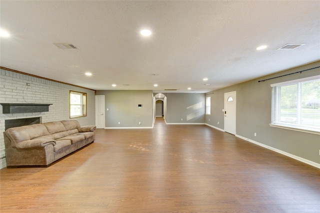811 Strange Dr, Richmond, TX 77406 - living room with visible vents, a brick fireplace, wood finished floors, and baseboards