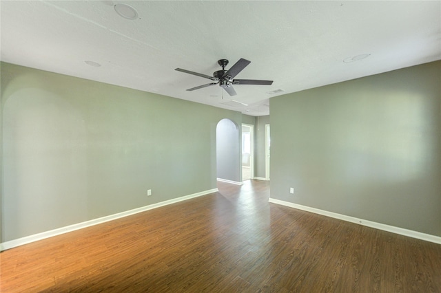 811 Strange Dr, Richmond, TX 77406 - empty room featuring baseboards, dark wood-style floors, a ceiling fan, visible vents, and arched walkways