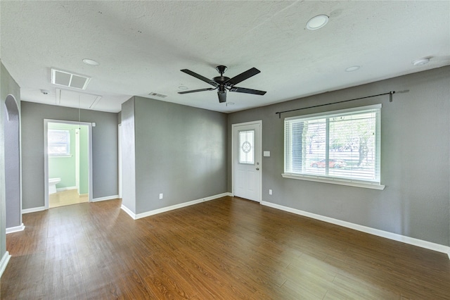 811 Strange Dr, Richmond, TX 77406 - unfurnished living room featuring ceiling fan, wood finished floors, attic access, and baseboards
