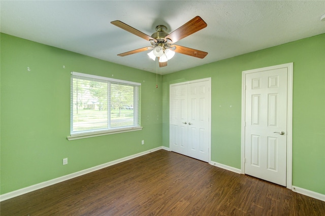 811 Strange Dr, Richmond, TX 77406 - unfurnished bedroom featuring dark wood-type flooring, a closet, baseboards, and a ceiling fan