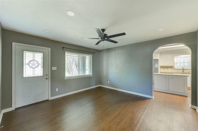 811 Strange Dr, Richmond, TX 77406 - foyer featuring ceiling fan, arched walkways, recessed lighting, wood finished floors, and baseboards