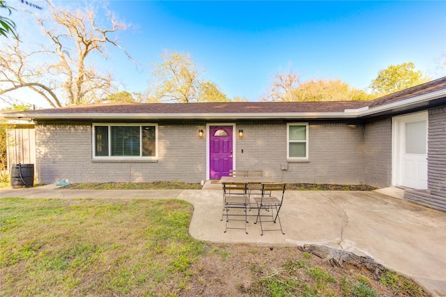 811 Strange Dr, Richmond, TX 77406 - rear view of property featuring a patio, brick siding, and a lawn