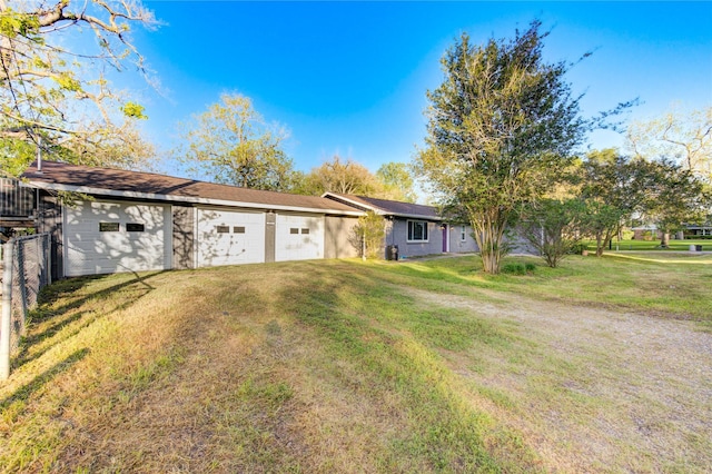 811 Strange Dr, Richmond, TX 77406 - ranch-style house featuring a front yard, driveway, fence, and a detached garage