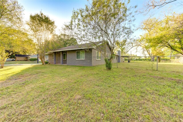 811 Strange Dr, Richmond, TX 77406 - view of side of home featuring a yard, fence, and brick siding