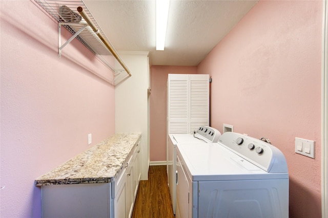 811 Strange Dr, Richmond, TX 77406 - washroom featuring separate washer and dryer, dark wood-style flooring, and cabinet space