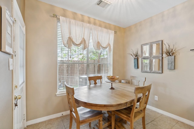 dining area featuring light tile patterned floors, baseboards, and visible vents