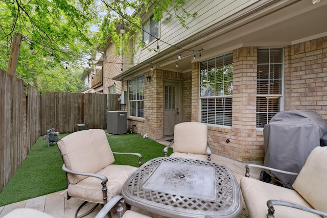 view of patio with cooling unit, grilling area, and a fenced backyard