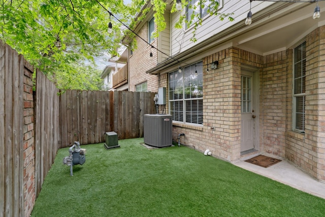 view of yard with a fenced backyard and cooling unit