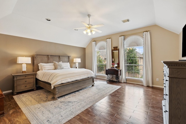 bedroom featuring dark wood finished floors, baseboards, lofted ceiling, and visible vents