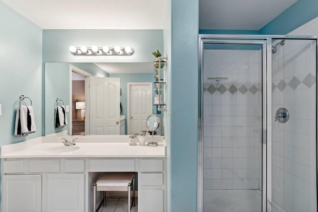 full bathroom featuring a stall shower and vanity