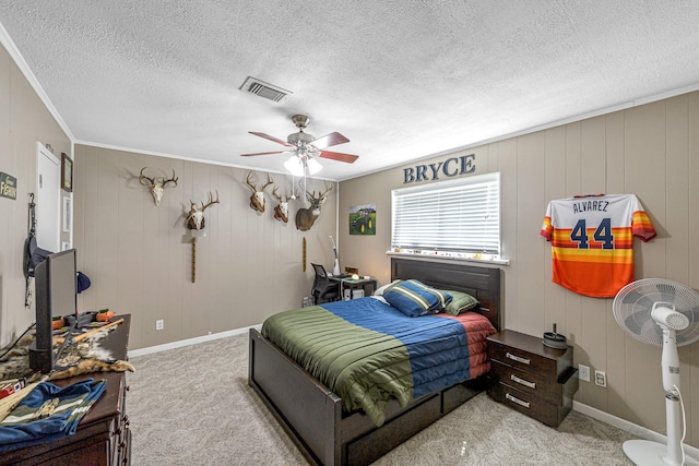 bedroom featuring carpet flooring, visible vents, crown molding, and ceiling fan