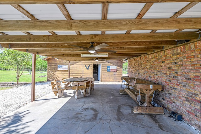 view of patio with outdoor dining space and a ceiling fan