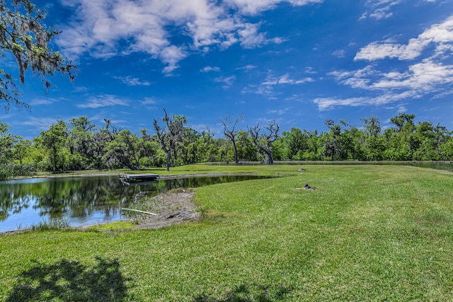 exterior space featuring a water view and a lawn