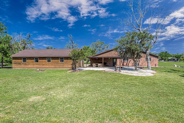 back of property with a patio and a yard