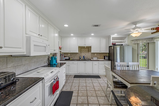 kitchen with white appliances, white cabinetry, backsplash, a ceiling fan, and a sink