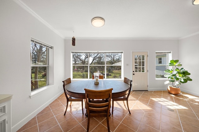 dining space with crown molding, a healthy amount of sunlight, baseboards, and tile patterned flooring