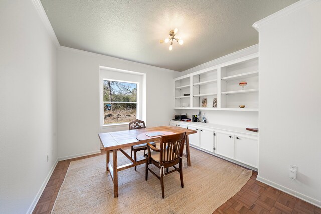 dining room with a textured ceiling, baseboards, and ornamental molding