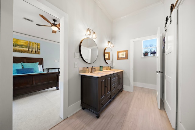 bathroom featuring visible vents, baseboards, ornamental molding, ceiling fan, and double vanity