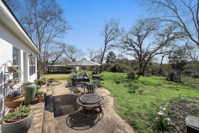 view of yard with a patio and a fire pit