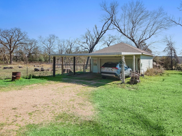 exterior space featuring a carport, driveway, and a yard