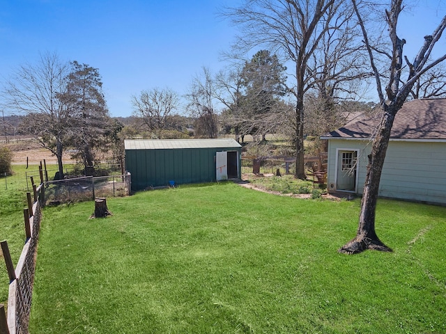 view of yard featuring an outbuilding and fence