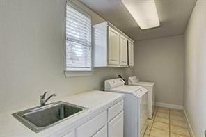 4810 N Pine Brook Way, Houston, TX 77059 - washroom with cabinet space, washer and dryer, baseboards, and light tile patterned floors