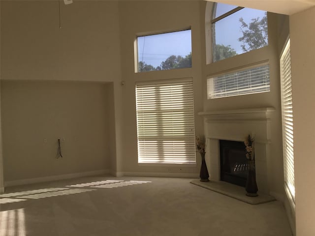 4810 N Pine Brook Way, Houston, TX 77059 - unfurnished living room with carpet, plenty of natural light, a tiled fireplace, baseboards, and a high ceiling