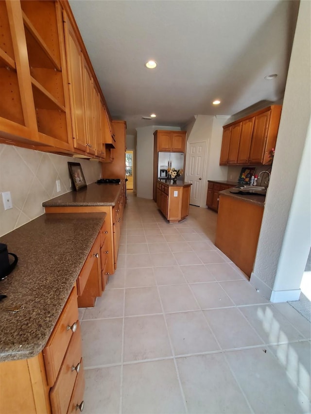 4810 N Pine Brook Way, Houston, TX 77059 - kitchen with stainless steel fridge, a sink, brown cabinetry, recessed lighting, and light tile patterned flooring