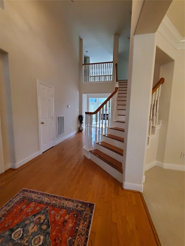 4810 N Pine Brook Way, Houston, TX 77059 - staircase with wood finished floors, baseboards, and a high ceiling