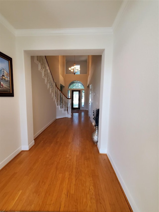 4810 N Pine Brook Way, Houston, TX 77059 - foyer entrance featuring a chandelier, light wood-style flooring, stairway, baseboards, and ornamental molding