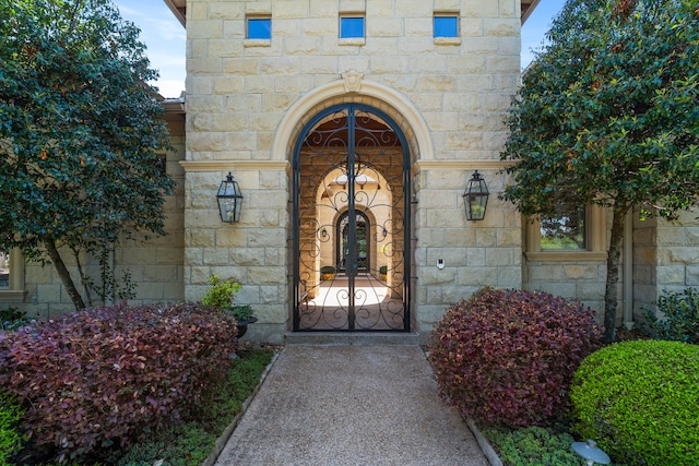 view of exterior entry featuring stone siding