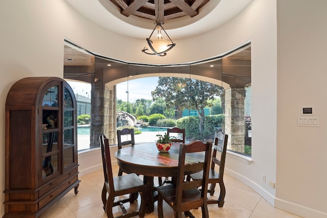dining space with coffered ceiling, light tile patterned floors, beamed ceiling, and baseboards