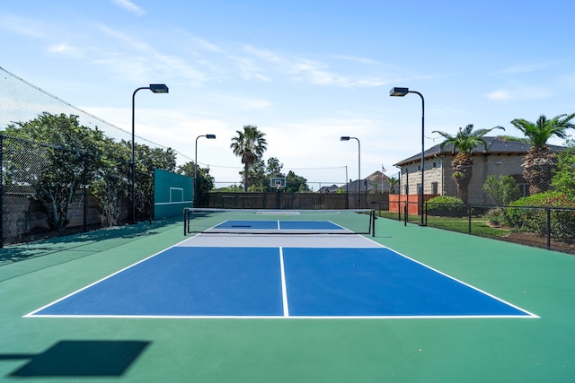 view of sport court featuring fence