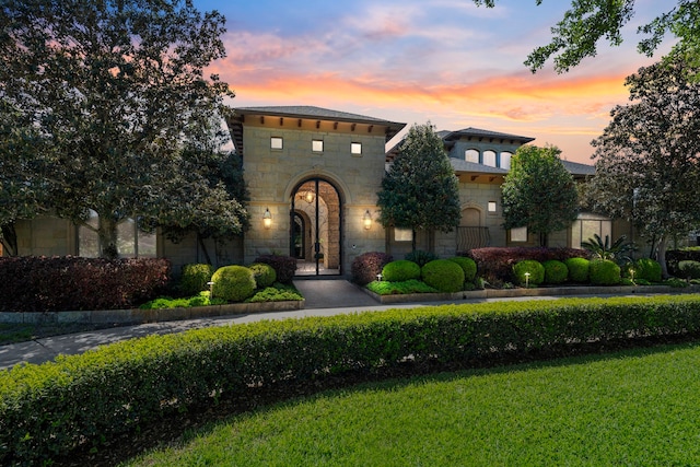 mediterranean / spanish home with stone siding