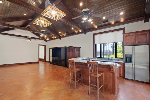 kitchen with wooden ceiling, stainless steel refrigerator with ice dispenser, ceiling fan, a breakfast bar, and vaulted ceiling with beams