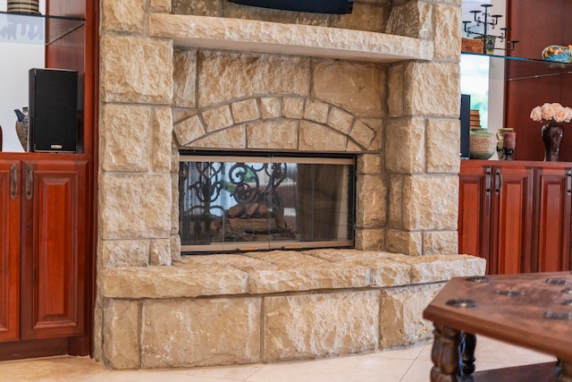 interior details featuring a stone fireplace