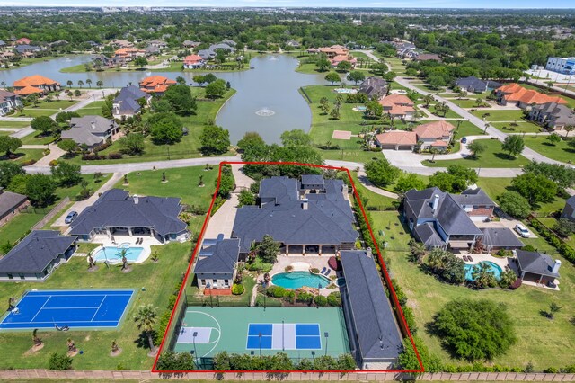 drone / aerial view with a water view and a residential view
