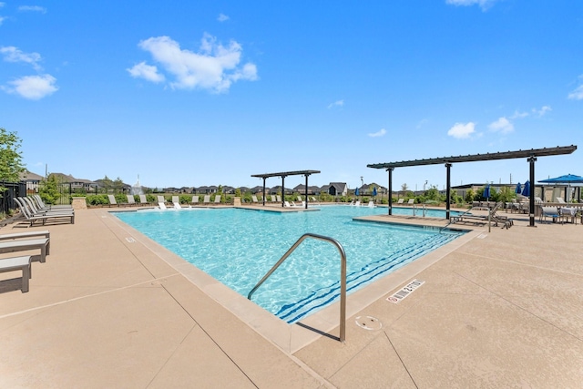 pool featuring a pergola and a patio area
