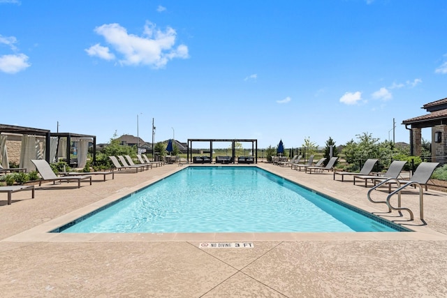 pool with a pergola and a patio area