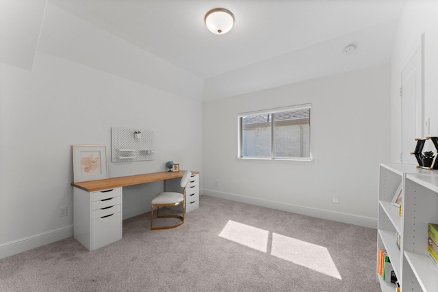 office space featuring light colored carpet, baseboards, and lofted ceiling