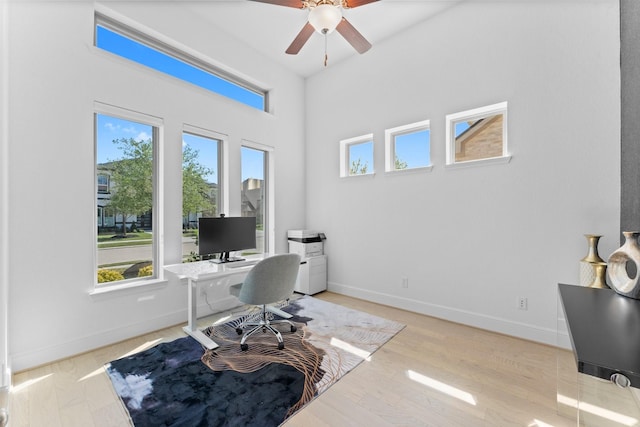 home office with baseboards and a ceiling fan