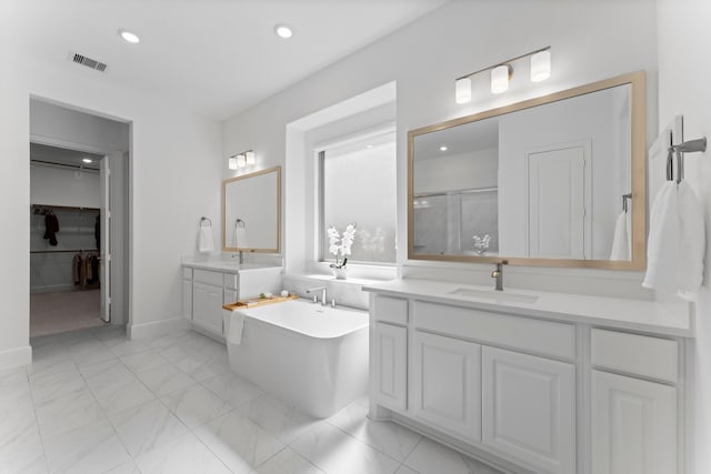 full bathroom with two vanities, visible vents, recessed lighting, a sink, and a stall shower