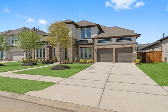 view of front facade with a front yard, fence, driveway, and stucco siding