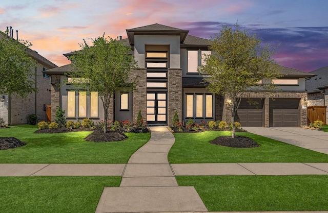view of front facade featuring concrete driveway, a garage, stucco siding, and a lawn