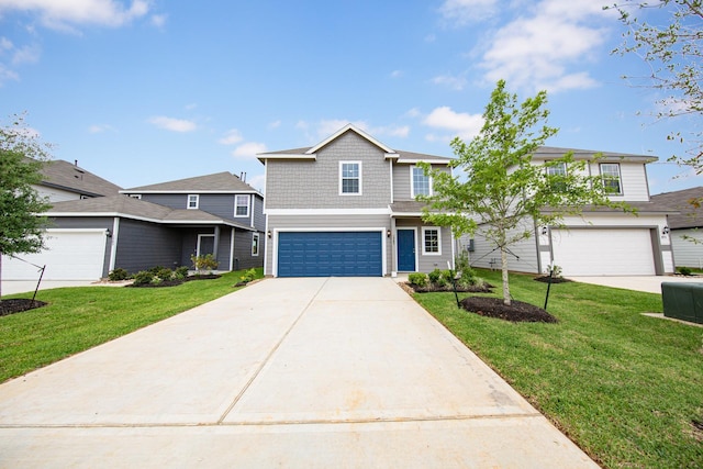 view of front of house featuring a front yard, concrete driveway, and a garage