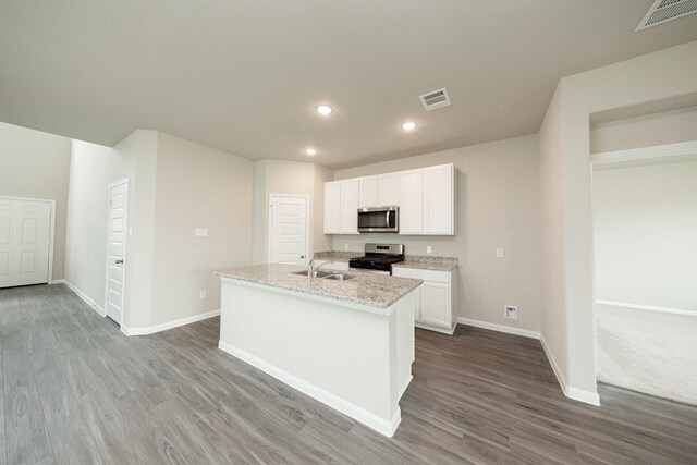 kitchen with baseboards, visible vents, appliances with stainless steel finishes, and wood finished floors
