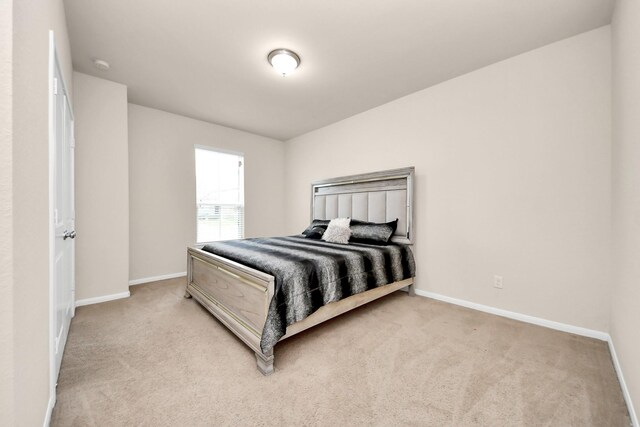 bedroom featuring carpet flooring and baseboards